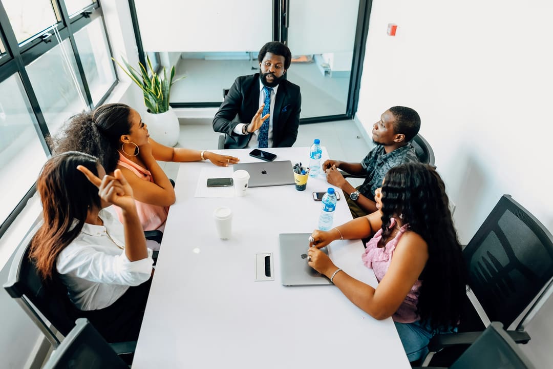 An executive leading a review with colleagues around a table